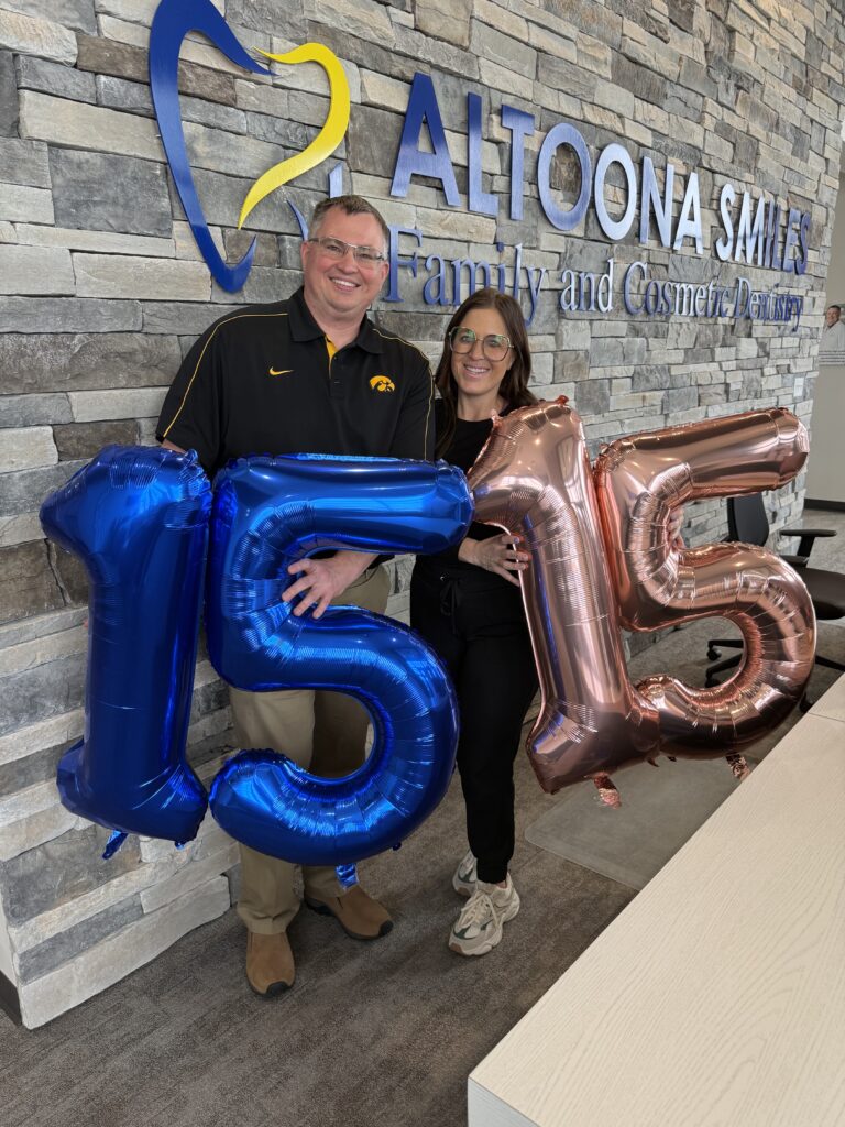 Dental team in Altoona, Iowa at the front desk holding balloons