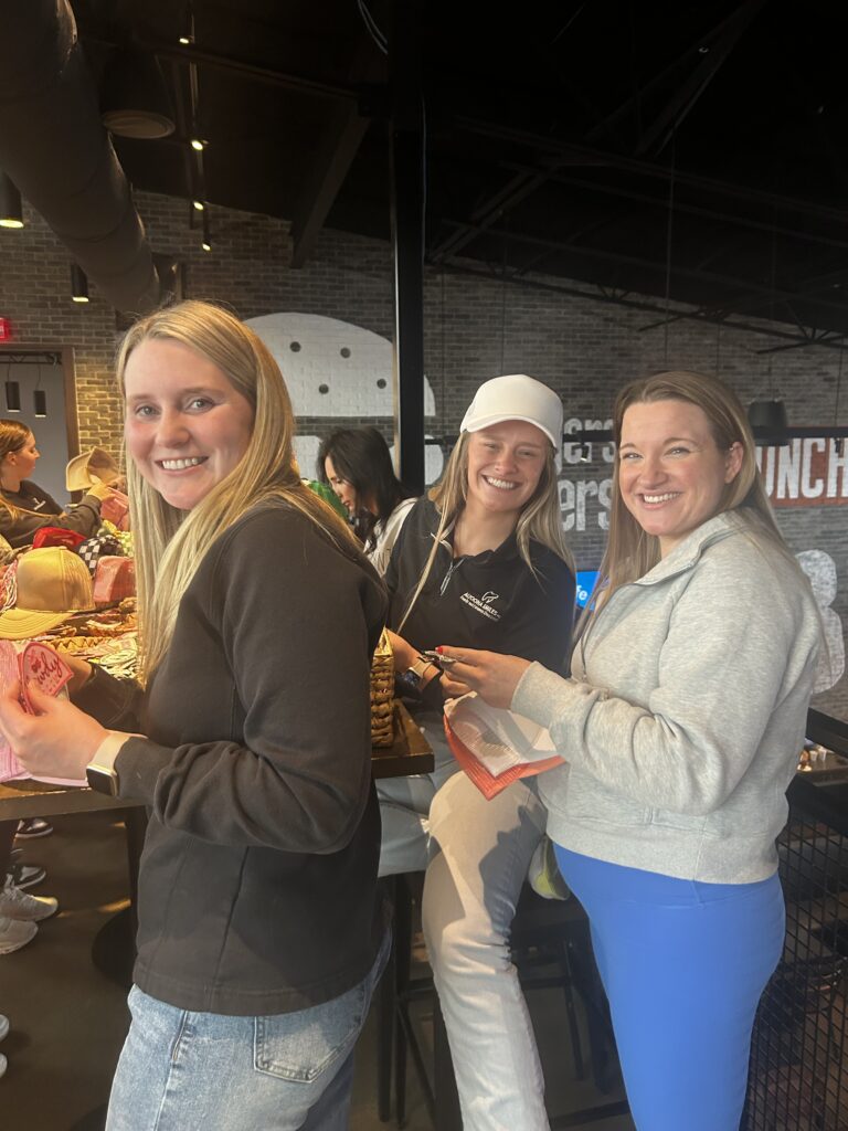 Dental team in Altoona, Iowa hanging out around a table, enjoying food and smiling