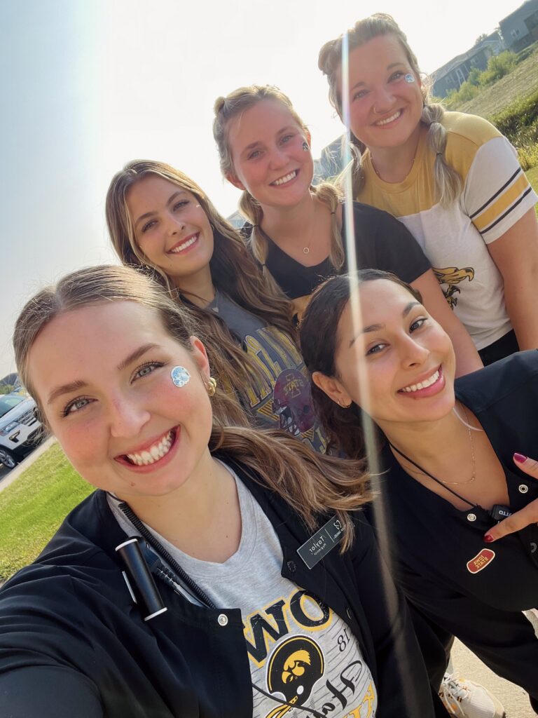 Dental team in Altoona, taking a selfie infront of a parking lot, smiling